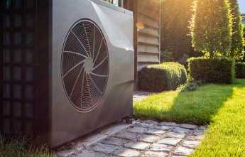 A heat pump in the backyard on a sunny day
