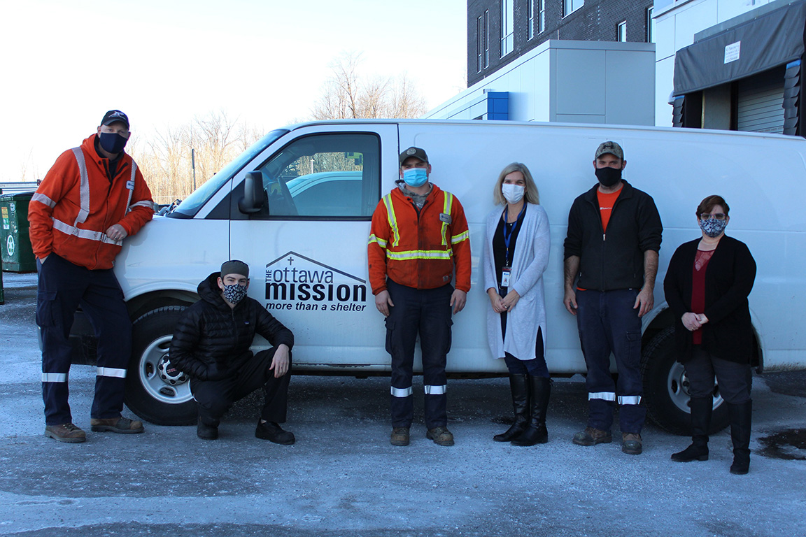 Hydro Ottawa employees in front of white Ottawa Mission van