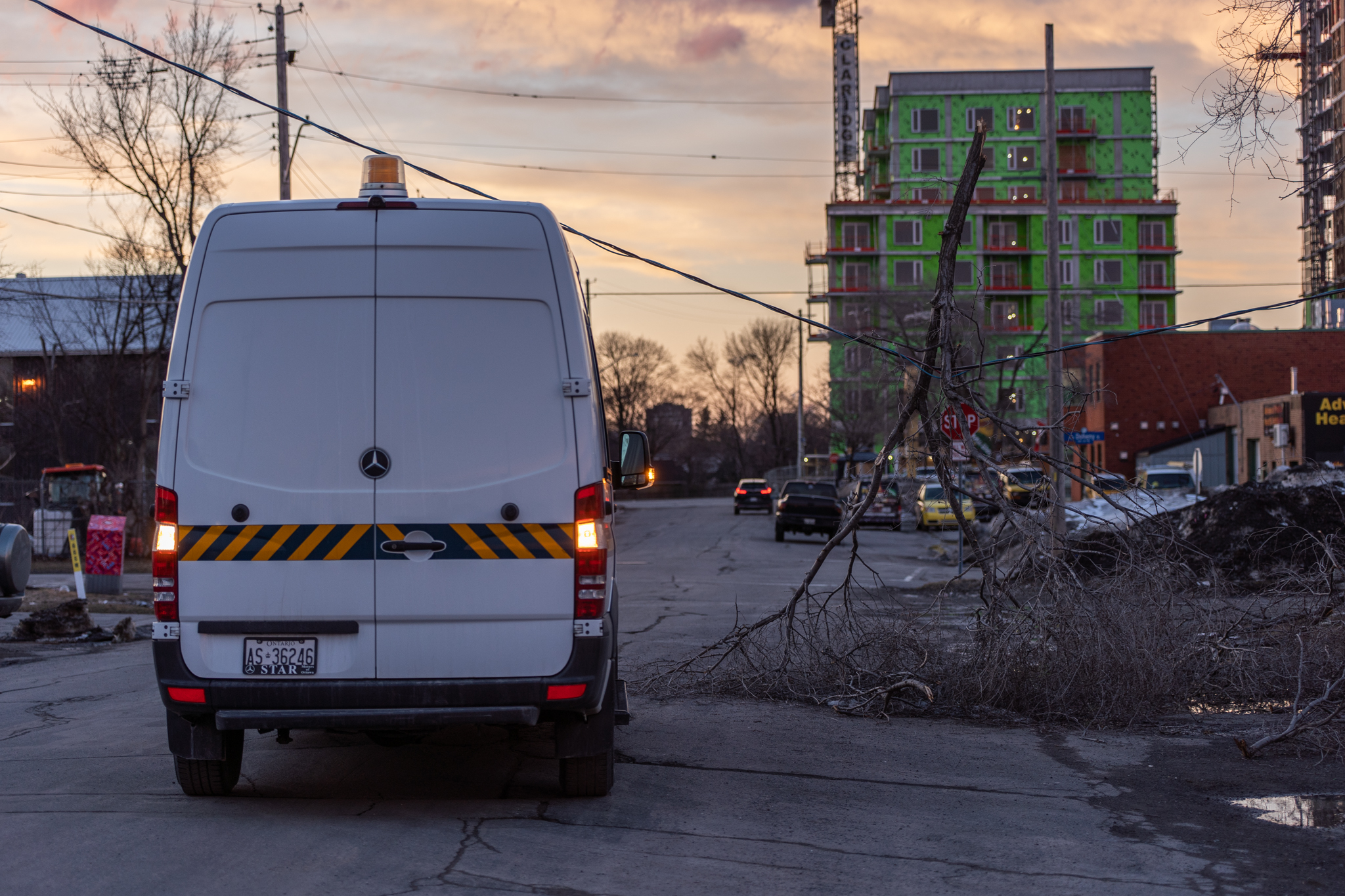 A white Hydro van appears next to a downed power line