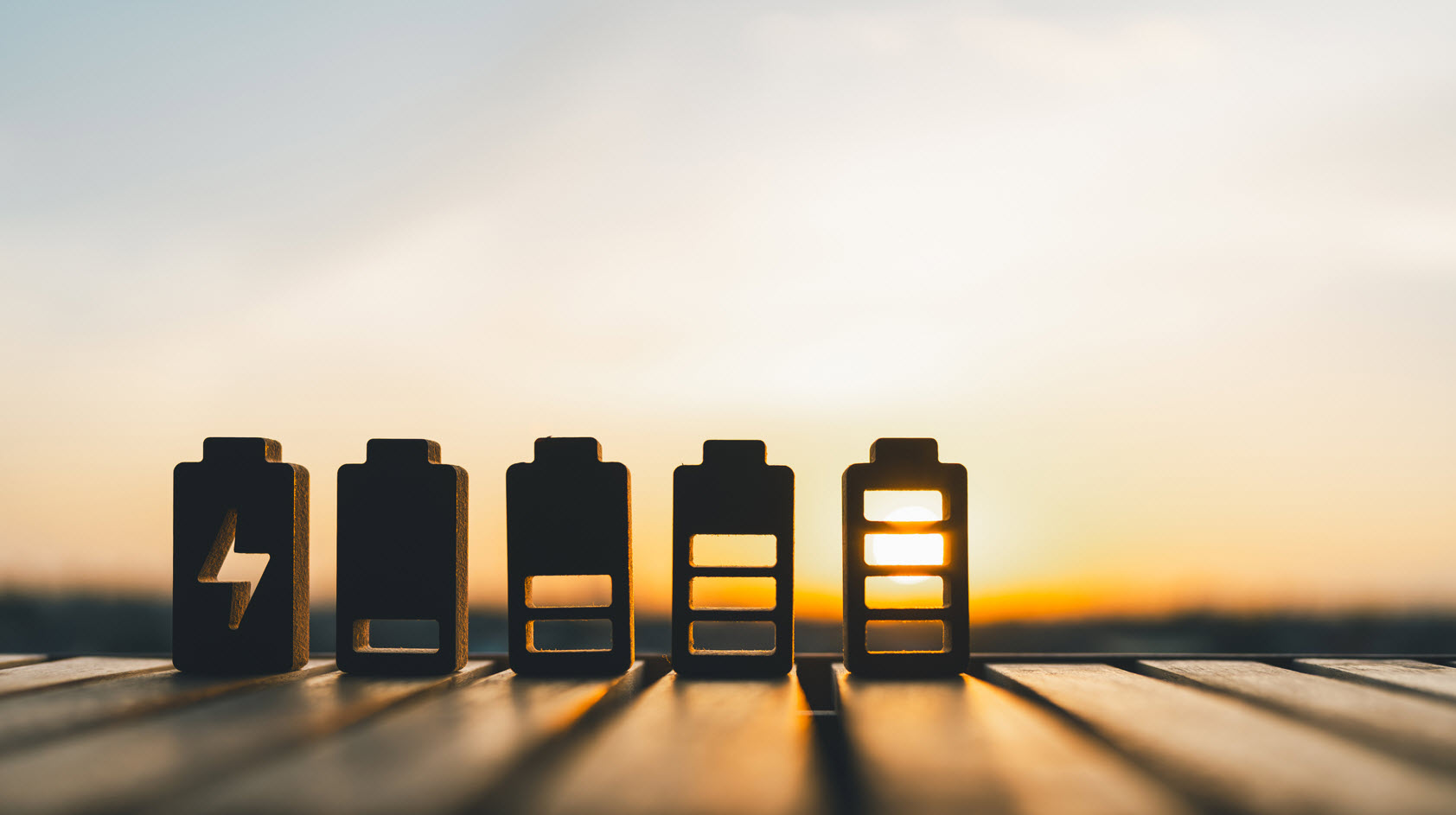 Small toy batteries with a sunset in the background