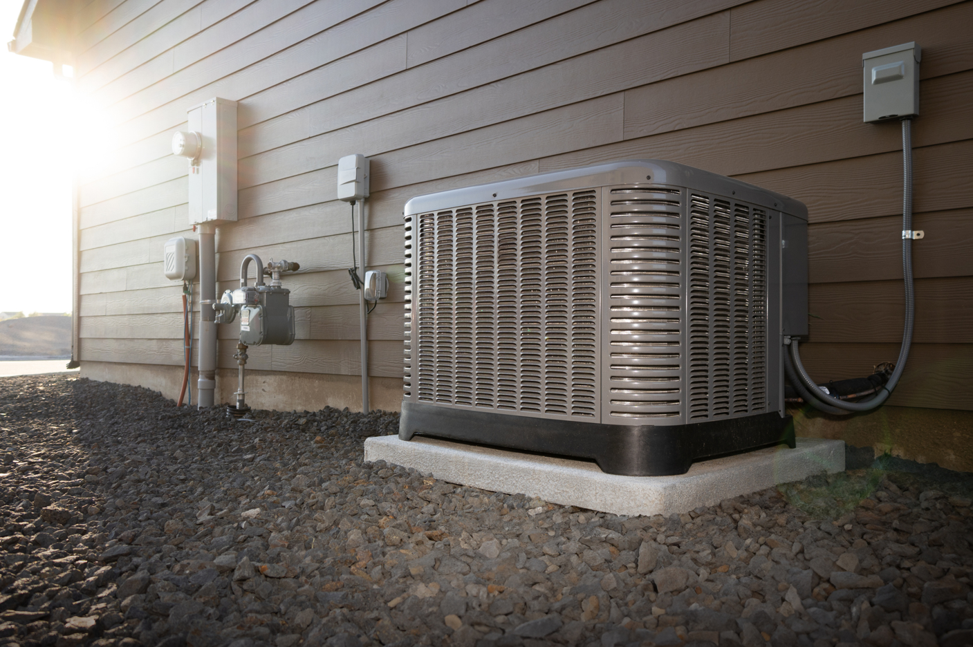 HVAC air conditioner unit on a concrete slab outside a house