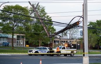 A hydro worker and police officer on scene after the May storm