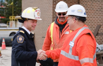 Ottawa Fire Chief, Paul Hutt, and Hydro Ottawa's Manager of Distribution shake hands