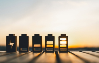 Small toy batteries with a sunset in the background