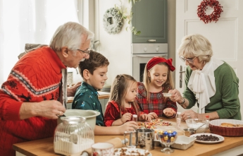 Grandparents Christmas baking with grandkids in kitchen