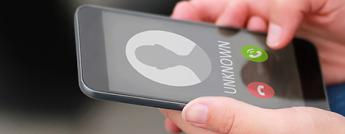 Mobile phone screen receiving a call from an unknown number 