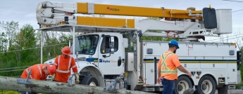 Hydro Ottawa crews attend to a downed hydro pole on May 22