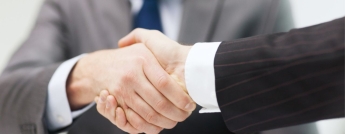 Two businessmen shaking hands in the office