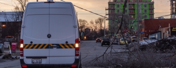 A parked hydro van near a downed wire and a tree branch covered in ice