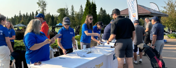 Hydro Ottawa employees sign in golf tournament participants