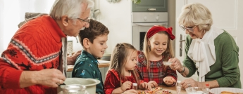 Grandparents Christmas baking with grandkids in kitchen